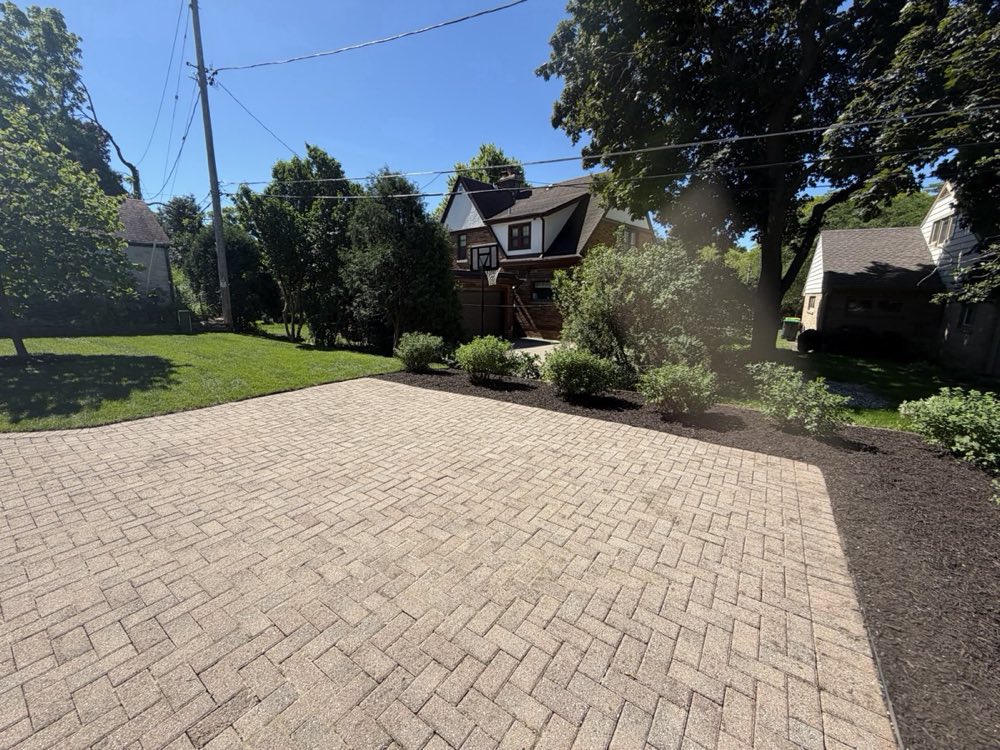 Finished brick paver driveway with shrubs in Milwaukee